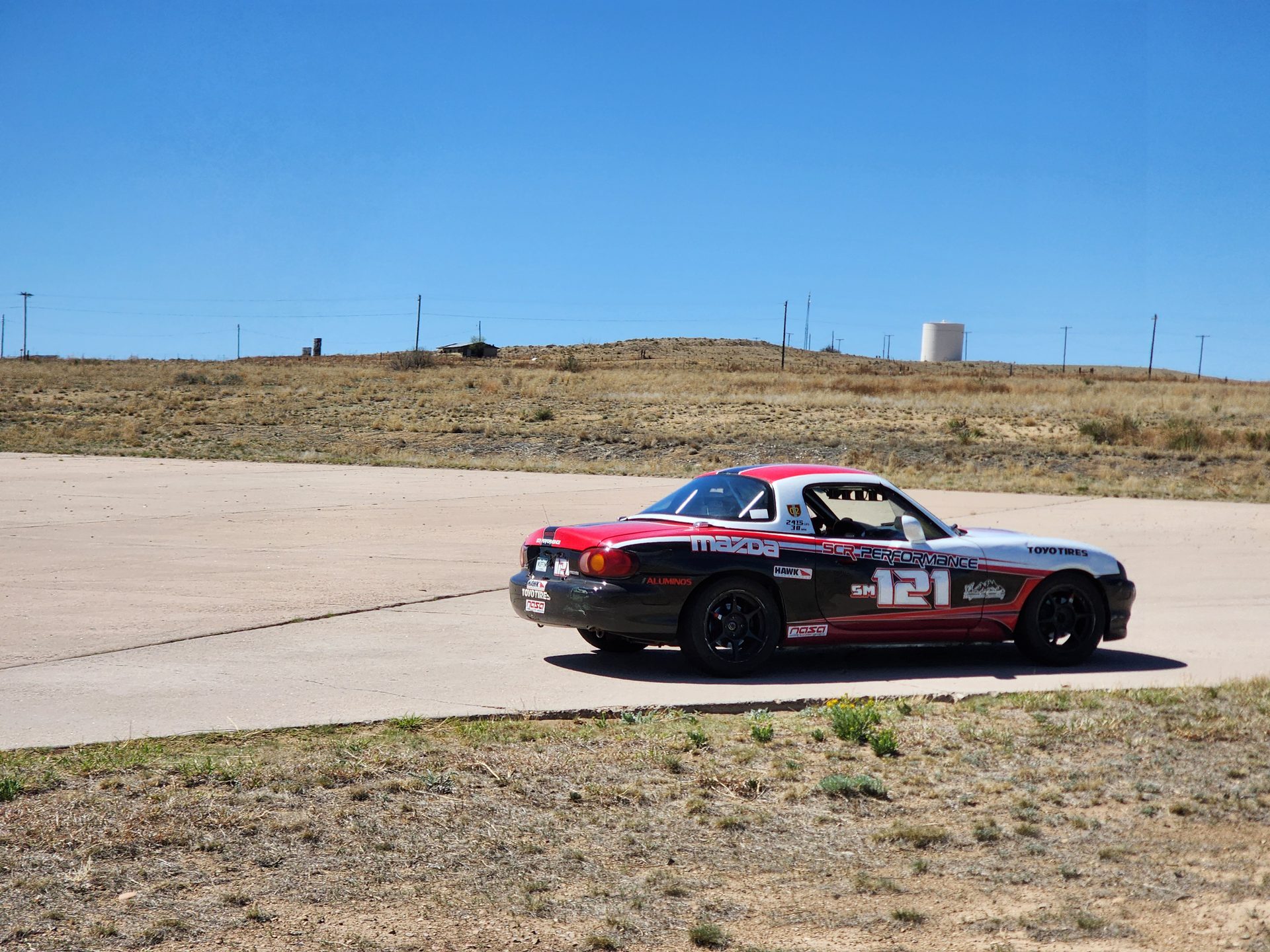 LFR Spec Miata #121, rear three-quarter on track
