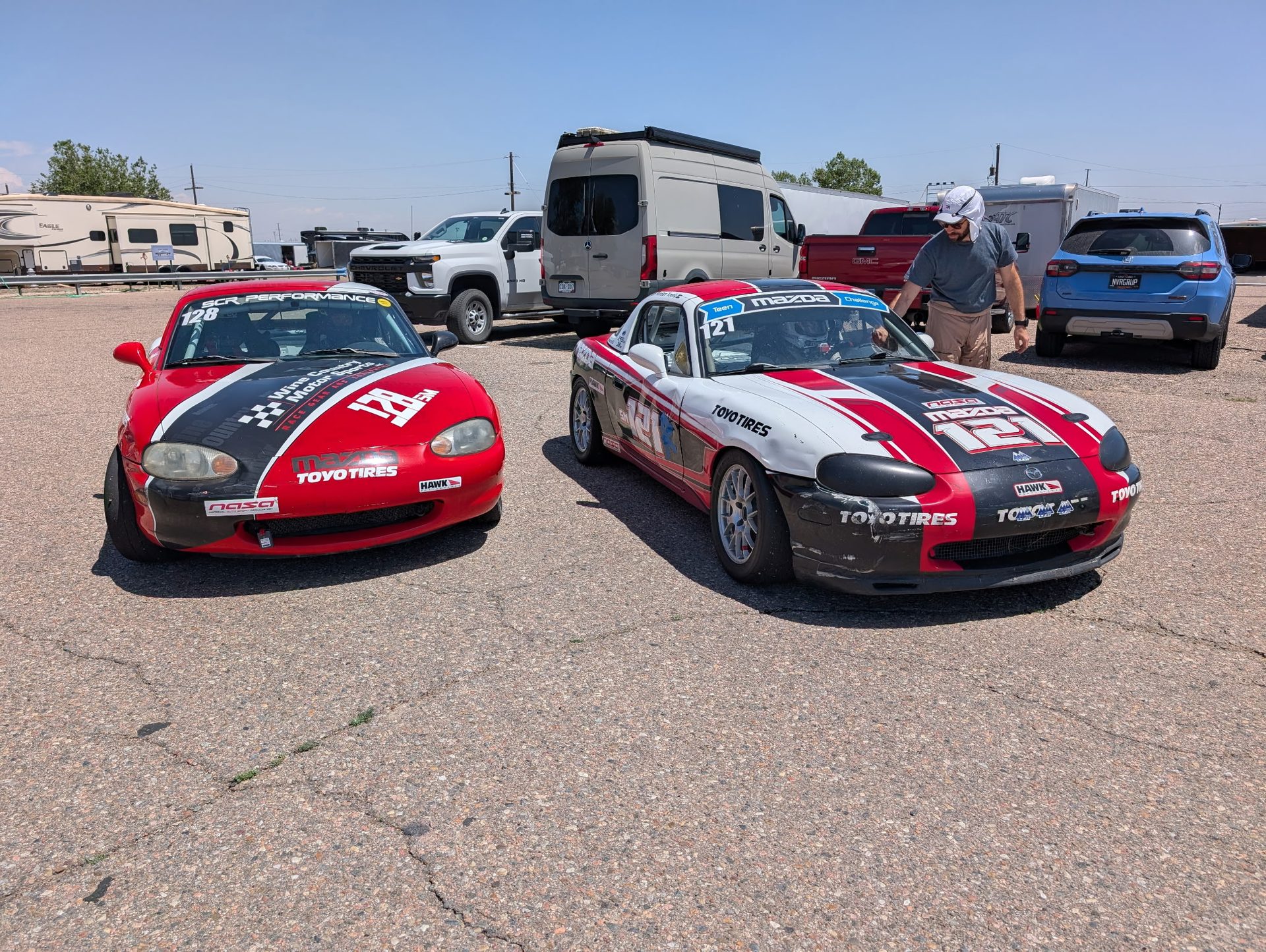 LFR Spec Miatas in the paddock at dusk after a race day